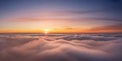 Obraz premium A breathtaking view above the clouds at sunset showcasing vibrant orange hues