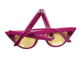 Isolated sunglasses in a folded position, pink frames and yellow lenses are visible against nothing