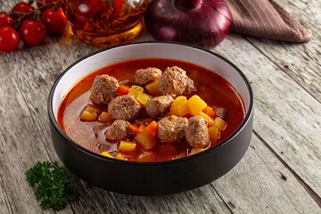 Tomato soup with meatballs and vegetables