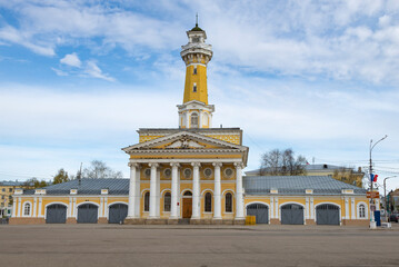 Building of the ancient fire station building with a fire tower on a cloudy May day. Kostroma, Golden Ring of Russia