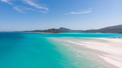 Aerial view of swirling sands meet the turquoise waters of Hill Inlet, a vista of pristine beauty from above, Whitsundays, Queensland, Australia.