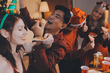 Festive Office Christmas Party with Delicious Food. A beautifully decorated office space with Christmas trees and festive lights, set up for a holiday party.