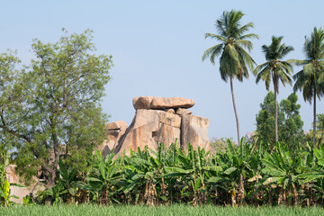 Hampi, rock formation, boulder landscape, coconut trees, banana plantation and rice field, South India