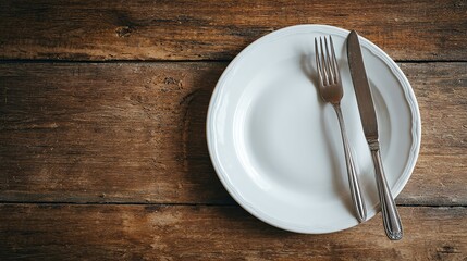 Empty White Plate with Silverware on Rustic Wooden Table