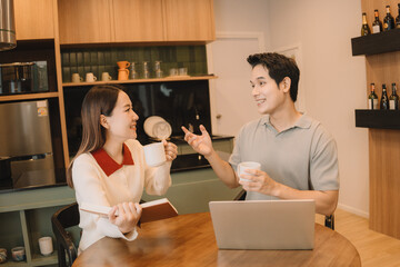 Happy Asian couple enjoying time together in their new home