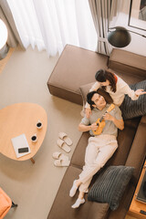 Happy Asian couple enjoying time together in their new home