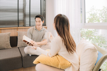 Happy Asian couple enjoying time together in their new home