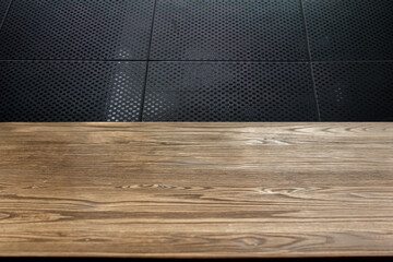 Wooden table surface separated from black background