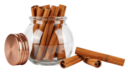 Isolated spices in a glass container are cinnamon sticks, with a copper lid, on display
