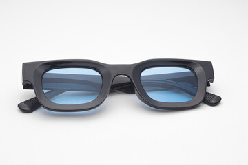 Trendy Black Rectangular Sunglasses with Blue Tinted Lenses Isolated on White Background