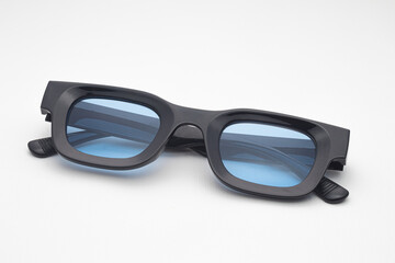 Trendy Black Rectangular Sunglasses with Blue Tinted Lenses Isolated on White Background