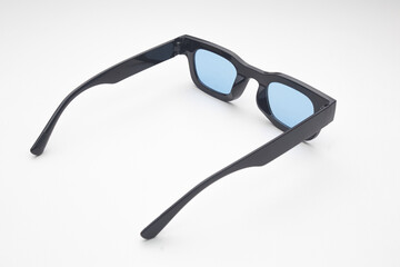 Trendy Black Rectangular Sunglasses with Blue Tinted Lenses Isolated on White Background