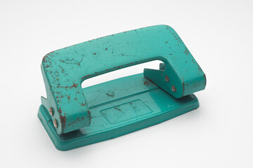 Old Rusty Teal Two-Hole Paper Punch Isolated on White Background