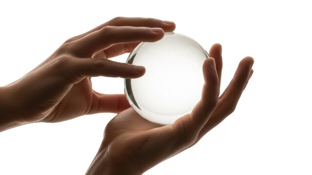 Isolated hands holding a crystal ball, showcasing its transparency and round shape, light shining