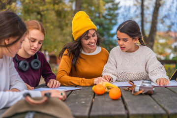 Mother helping daughters with outdoor homework session