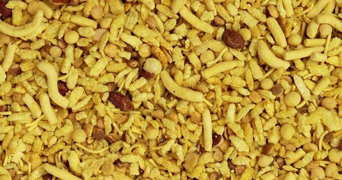 Traditional indian deep fried salty dish - chivda or farsan or namkeen made of gram flour and mixed with dry fruits, selective focus