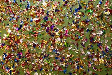 Colorful confetti on green background.