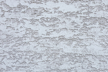 Textured white wall with a rough surface. The wall features a subtle pattern, creating a visually interesting backdrop for various applications.