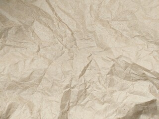 Fototapeta premium Crumpled old brown vintage paper texture background. Wrinkled kraft paper surface with copy space for design.