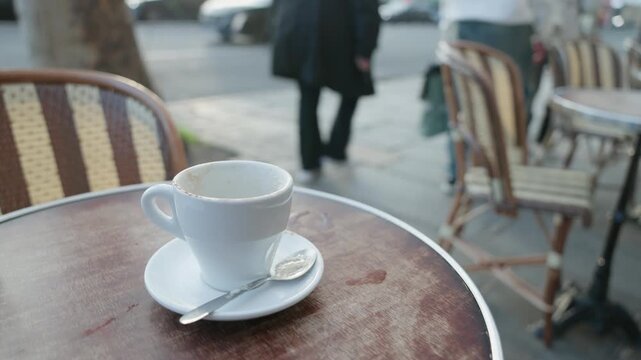 Empty Cappuccino Cup at Street Cafe with Evening Bokeh in Paris France