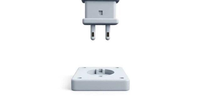 Disassembled gray electrical plug and socket on a white background with a minimalist composition.