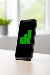 Phone on nightstand displaying achieved savings goal, Financial independence