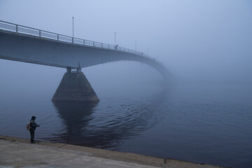At the Humpbacked Bridge on the Volkhov River on a foggy October morning. Veliky Novgorod, Russia