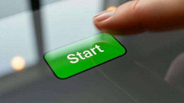 Close-up of a person's finger pressing the green start button on a touchscreen device in a modern