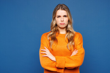 Young sad upset grumpy frowning Caucasian woman she wear yellow sweater casual clothes holding...
