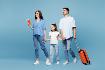 Traveler parents mom dad child wear casual clothes hold passport ticket bag go isolated on plain...