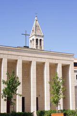 A low-angle view of the towering Romanesque bell tower of Saint Domnius Cathedral, part of the historic Diocletian's Palace complex in Split.