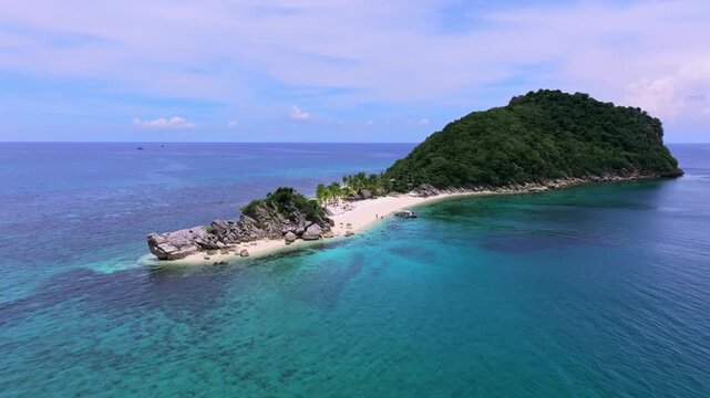 Aerial view of an island with white sandy beach, turquoise waters, and lush green vegetation, Carles, Western Visayas, Philippines.