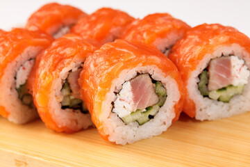 Colorful sushi rolls arranged beautifully on a wooden platter