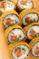 Delicious crunchy sushi rolls served on a wooden platter