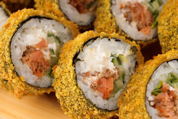 Crispy sushi rolls filled with fresh fish and vegetables in close-up