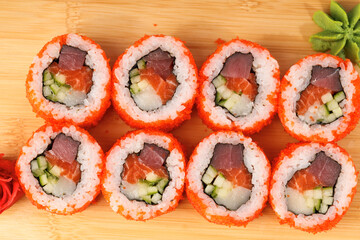 Colorful sushi rolls arranged beautifully on a wooden board