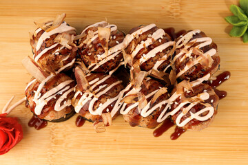 Delicious takoyaki balls topped with sauce and bonito flakes