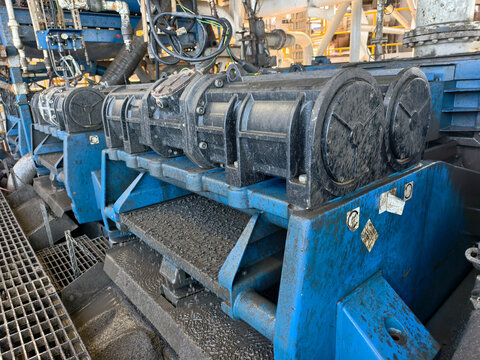A shale shaker on an oil rig is a vibrating screen that separates large drilled solids, or cuttings, from the drilling fluid, or mud.