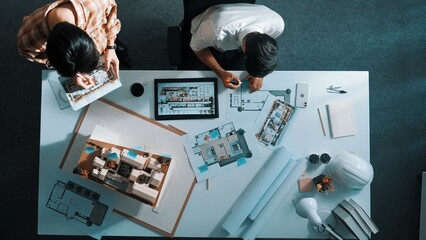 Top view of business man working together to design house. Aerial view of architect engineer looking at tablet display blueprint. Aerial view of manager discussing about house structure. Alimentation.