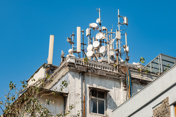 5G and 4G Mobile network directional antennas on the roof of residential building