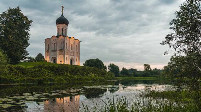 timelapse of sunrise and fast-moving clouds in the sky above The Church of the Intercession on the Nerl River, Russia