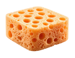 A porous, square-shaped, orange object against a black background