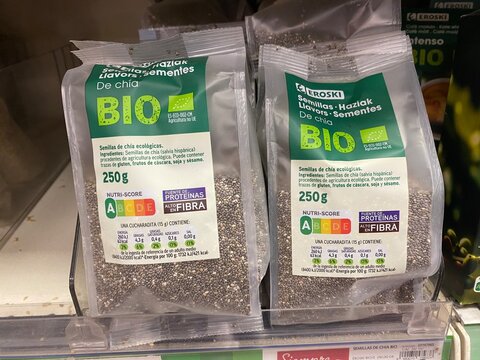 Palmanova, Spain - December 1, 2025: Eroski organic chia seeds packaged for sale in supermarket, showcasing nutri score a, high protein, and high fiber content for healthy eating choices