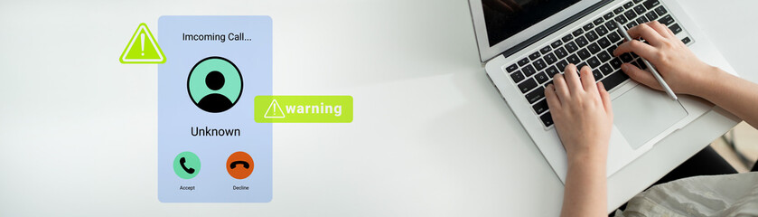An individual receives an incoming call notification on a laptop, displaying an alert and warning icon, symbolizing the blend of communication and technology in daily life. Gantry