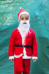 child dressed as santa claus at outside festive season