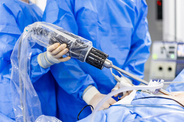 Powered surgical instrument used in procedure. Precision medical device applied during operative workflow