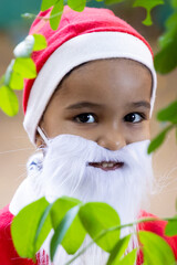 small child dressed as santa claus outdoors holiday concept