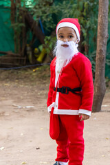child dressed as santa claus playing outside festive season