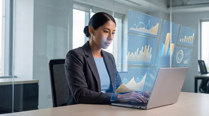 Female analyst reviewing business data visualizations on laptop screen