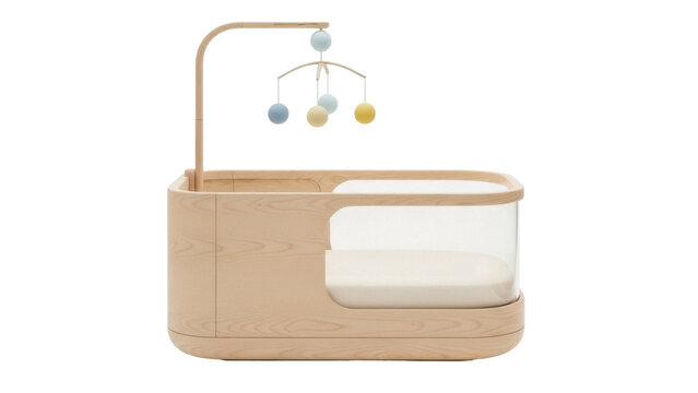 Isolated wood baby crib, clear side panel and colorful mobile for newborn infant, natural lighting
